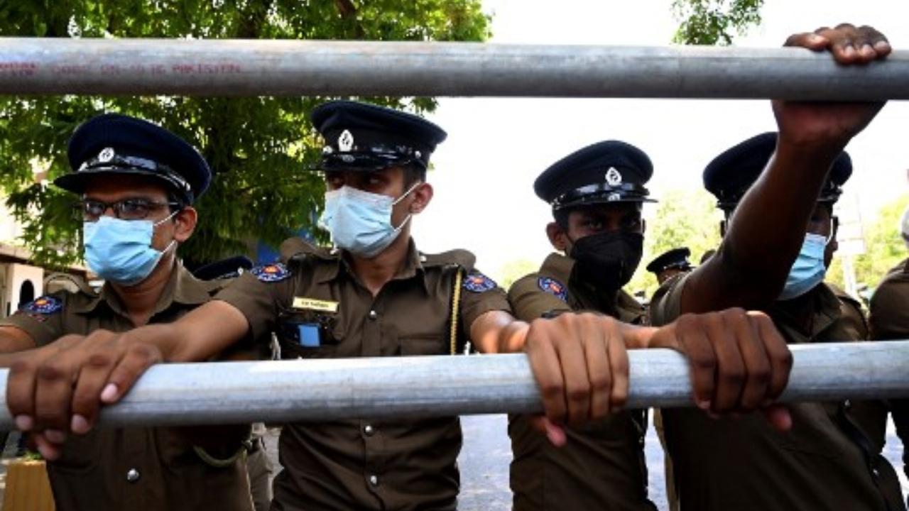 Police stand guard as main opposition parliament members protest on April 3 in Colombo. Heavily armed Sri Lankan security forces blocked a march led by opposition legislators who had defied a weekend curfew to protest nation's crisis.